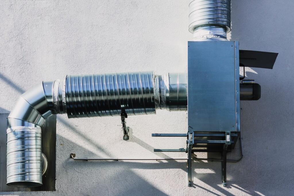 Heat recovery ventilator unit showing ventilation tubes and built-in fan mechanism