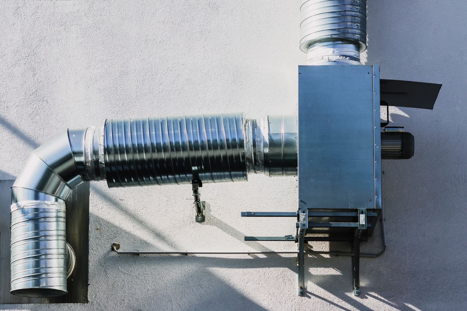 Heat recovery ventilator unit showing ventilation tubes and built-in fan mechanism