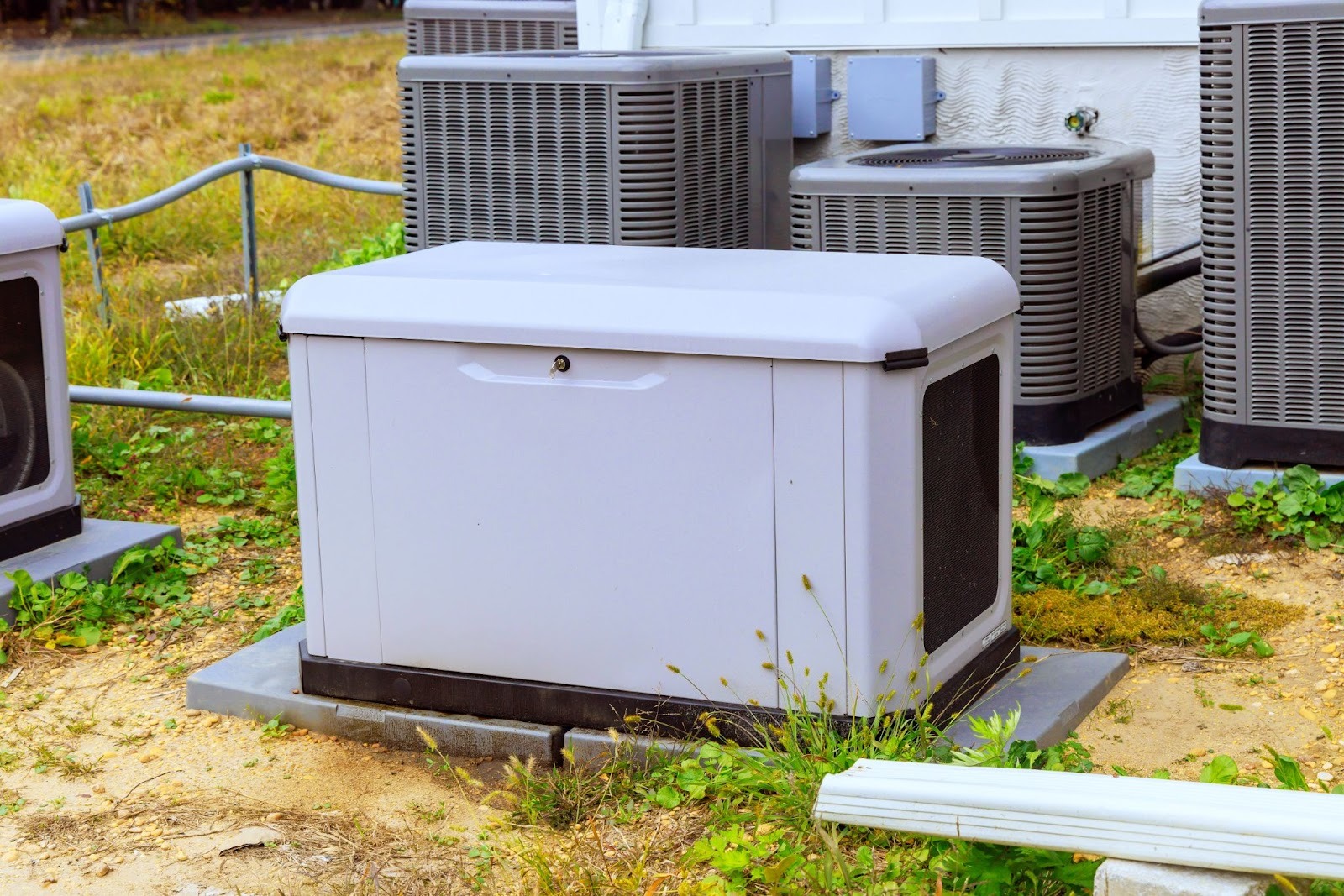 Home backup generator installed near outdoor air conditioner units